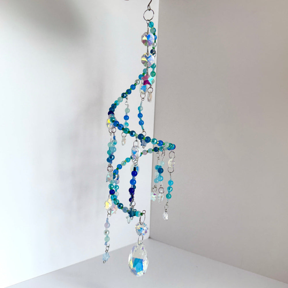 Colorful beaded hanging decoration on a white background