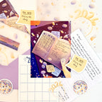 Collection of stationery items including envelopes, cards, and stickers on a white background