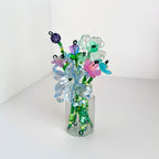 a glass jar with a variety of beaded flowers