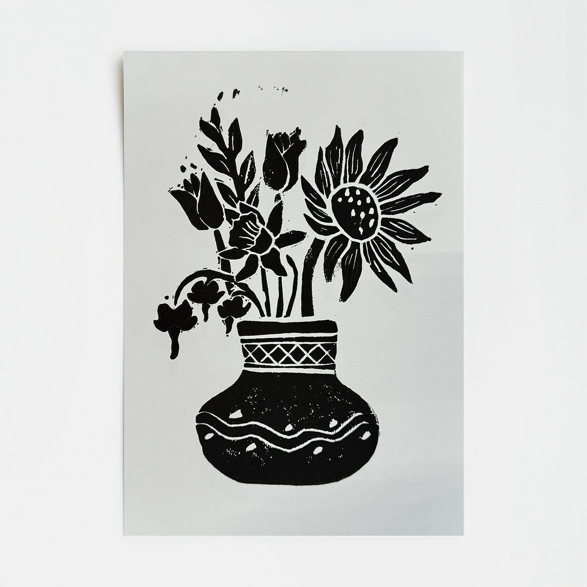 Black floral and vase illustration on a white background